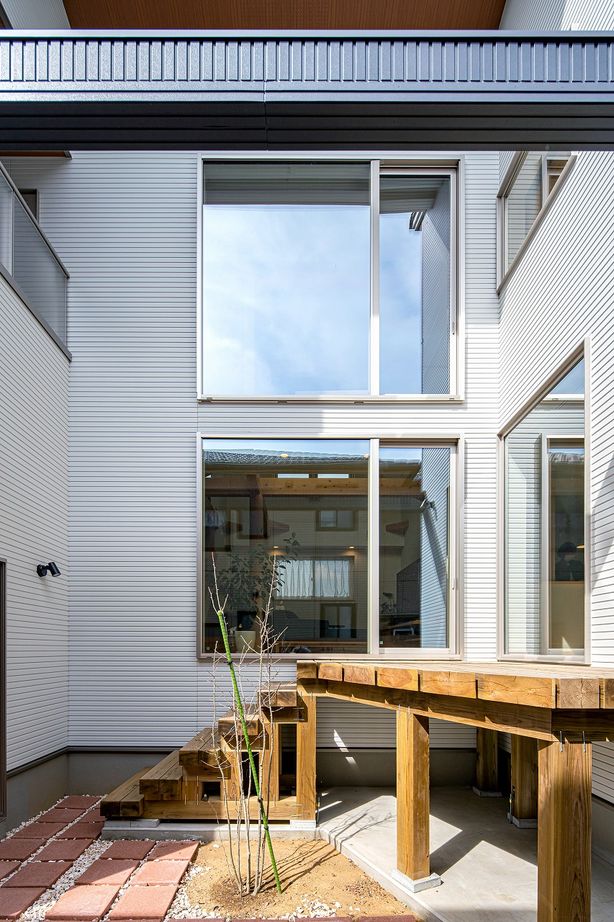 棟匠 ビルトインガレージと半地下空間で趣味を愉しむ。デッキのあるコの字型の木の家の建築実例画像2