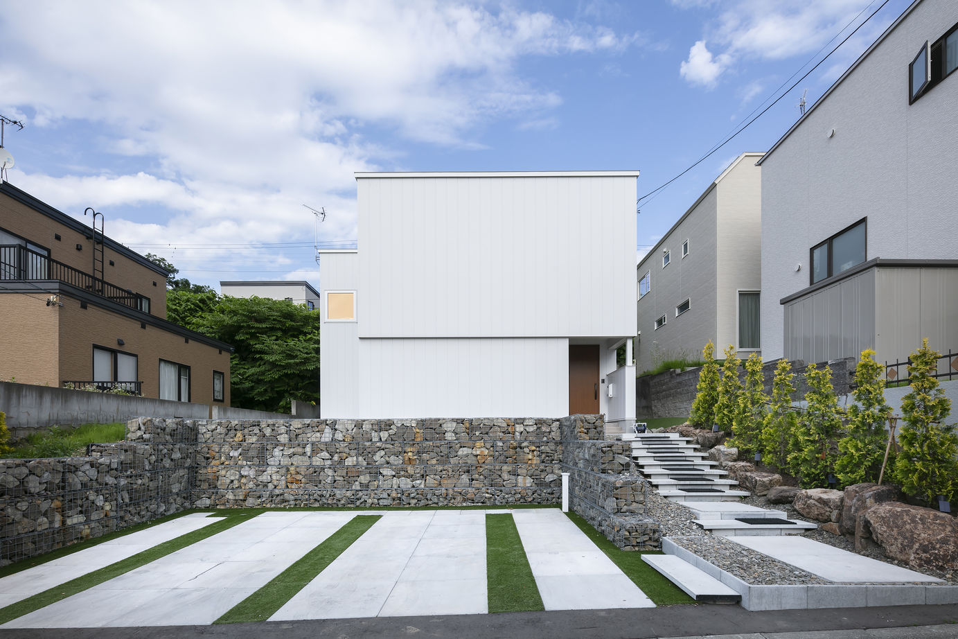 スカイハウス 【札幌市/3000万円台/カーポート/テラス】白い外壁にガビオンフェンスと緑が映える家の建築実例画像