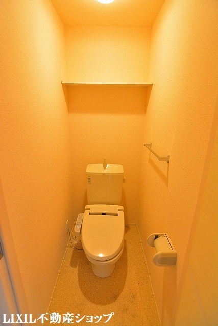 トイレ　上部に収納棚のある温水洗浄便座付のトイレです。