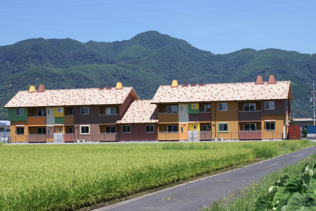 建物外観　田園風景の中のカラフルな洒落たアパート