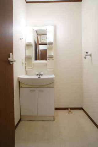 洗面設備　独立洗面所内の洗髪洗面化粧台と洗濯機置場です