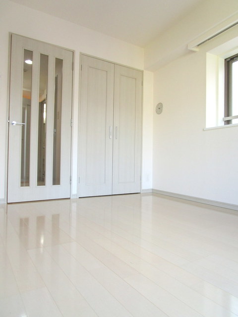 居室・リビング　白を基調とした6.4帖の洋室