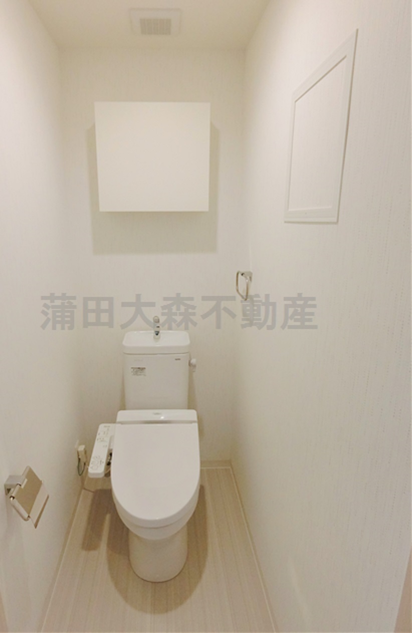 トイレ　棚収納と温水暖房便座付きのトイレ