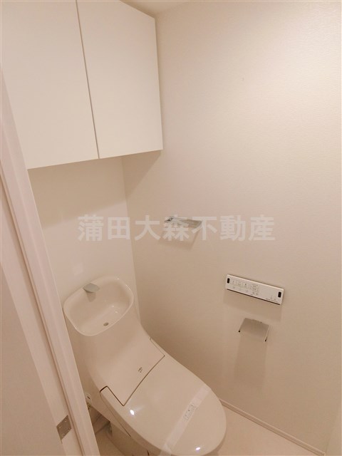 トイレ　棚収納に温水暖房便座付きのトイレ