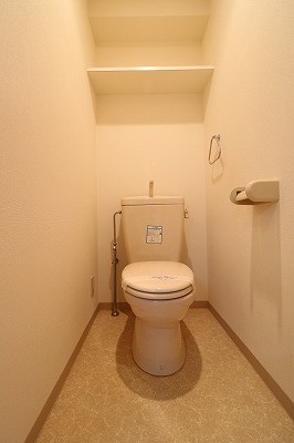 トイレ　背面上部には棚があるので消耗品の収納ができます。