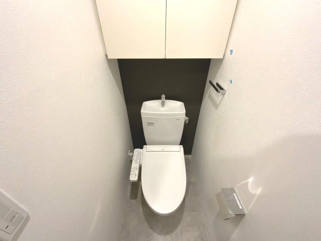 トイレ　【上部に戸棚があり収納に困らない】アクセントクロスがおしゃれ