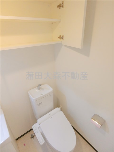 トイレ　吊戸棚収納と温水洗浄暖房便座付きのトイレ