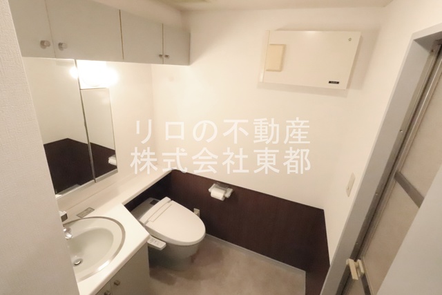 洗面設備　トイレの上まで吊戸棚があります。