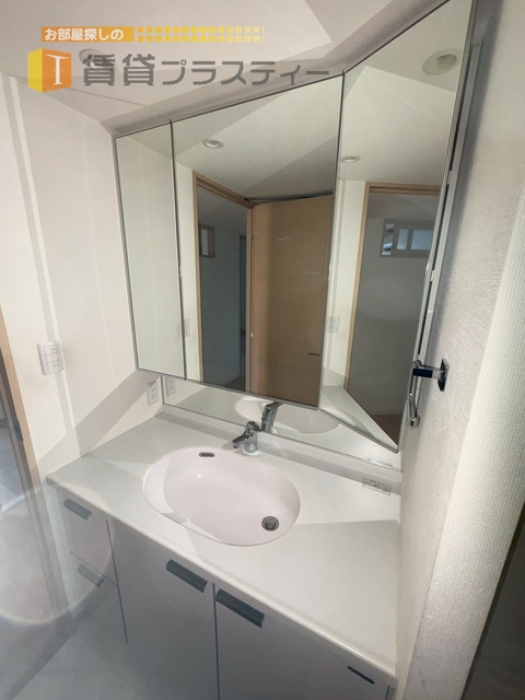 洗面設備　機能的な三面鏡仕様の洗面台。