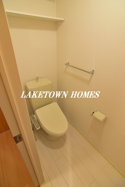 トイレ　上部に収納棚のある温水洗浄便座付のトイレです。