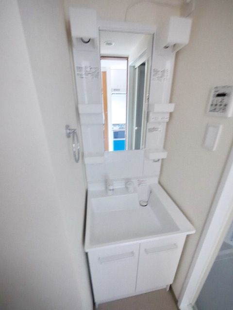 洗面設備　※お部屋の階数により建具の色合いが違います　現況優先