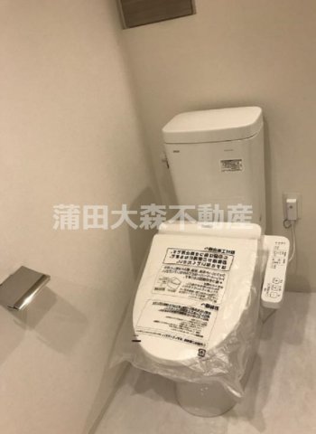 トイレ　棚収納と温水洗浄便座付きのトイレ