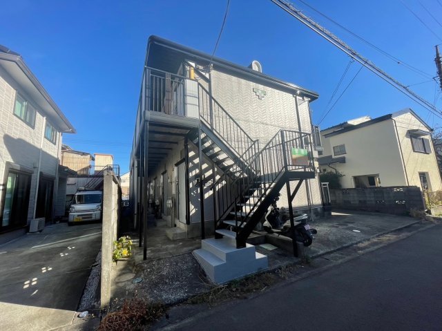 建物外観　玄関側の隣地との境には塀がございます。