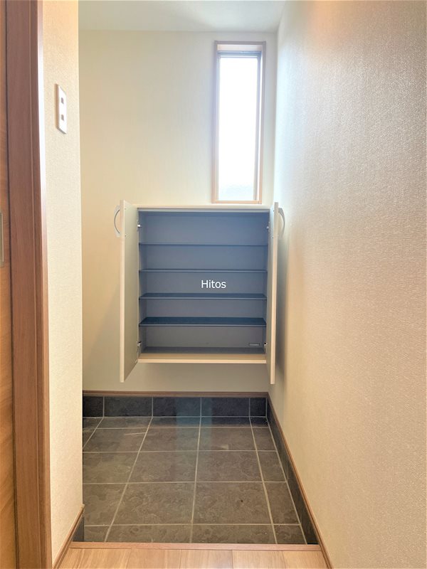 玄関　小窓つきの明るい玄関。L字型でプライバシーにも配慮。