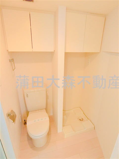 トイレ　棚収納付のトイレと洗濯機置き場